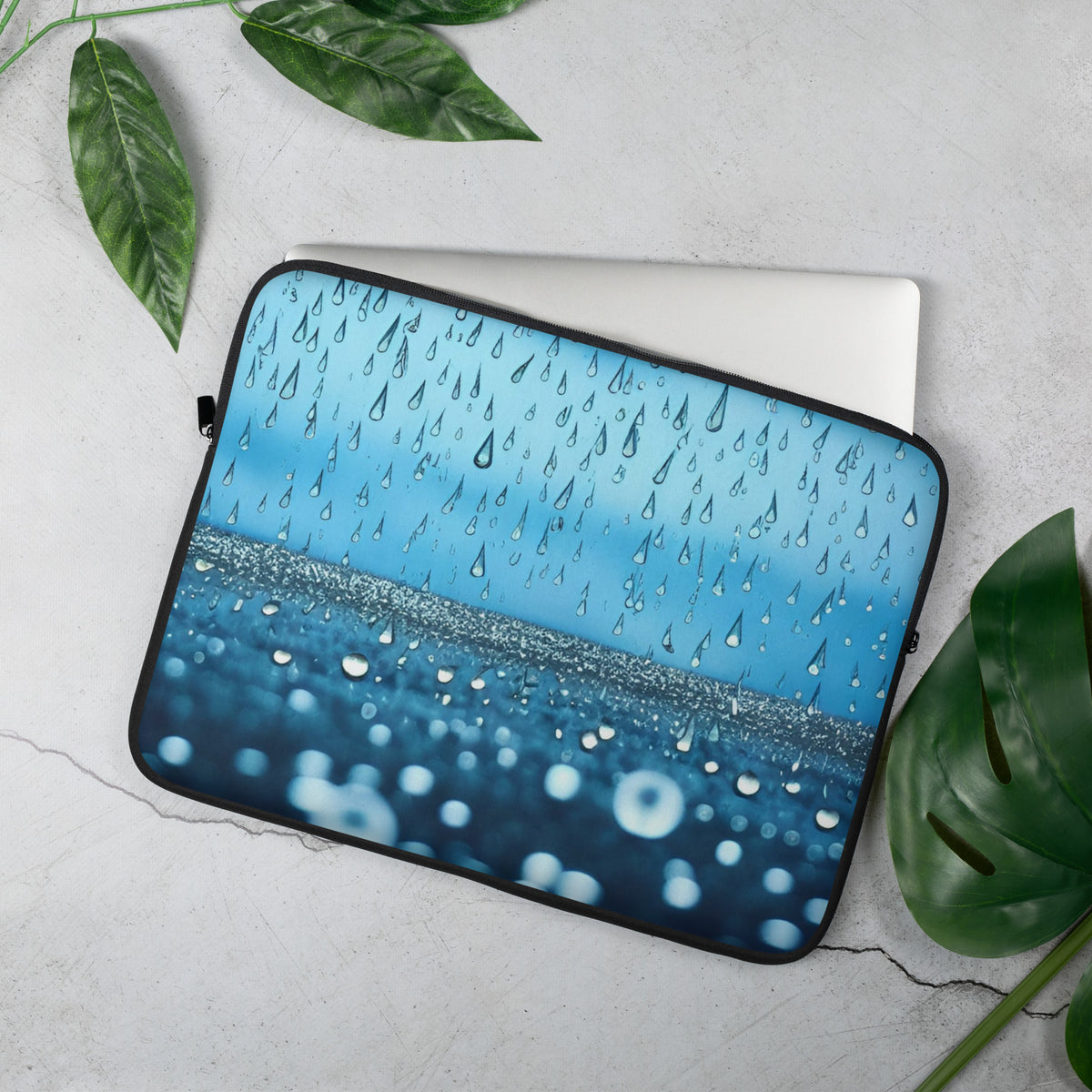 Blue laptop sleeve with falling raindrops and water bubble design pattern