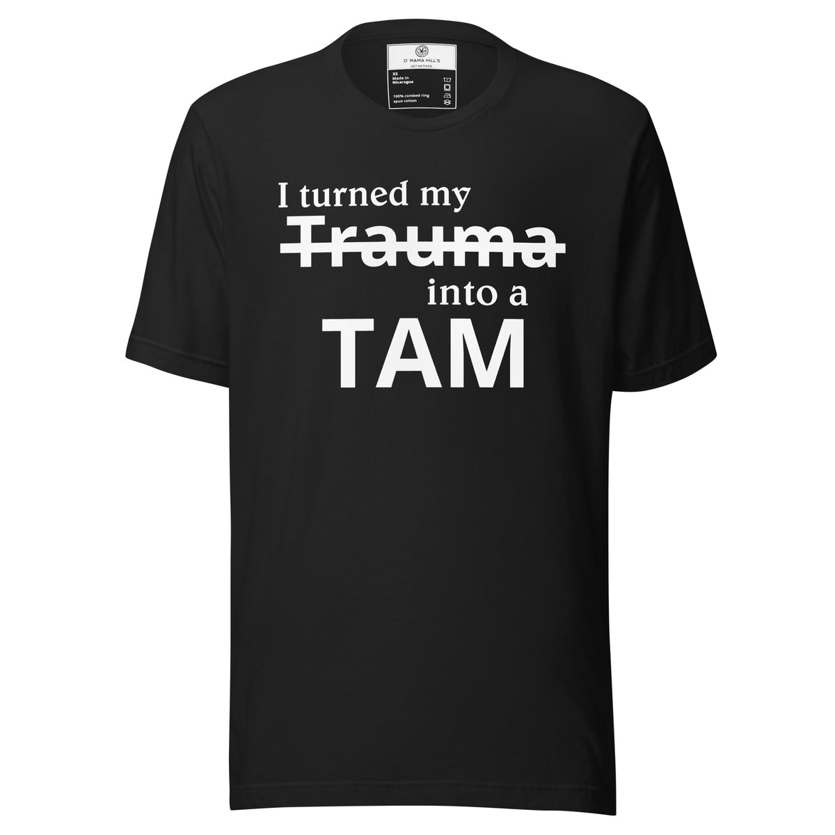 Black t-shirt with white text 'I turned my' and strikethrough 'Trauma', 'into a' and bold 'TAM' below